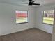 Bedroom with neutral carpet and windows looking out to the back yard at 362 Pasco Ct, Winter Haven, FL 33884