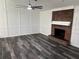 Living room with hardwood floors, white trim, and brick fireplace at 362 Pasco Ct, Winter Haven, FL 33884