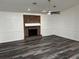 Cozy living room featuring a brick fireplace and decorative white wainscotting at 362 Pasco Ct, Winter Haven, FL 33884