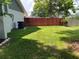 Green side yard with a wood fence and an air conditioning unit attached to the home at 362 Pasco Ct, Winter Haven, FL 33884