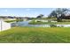 Expansive backyard overlooking a serene pond, enclosed by a white fence, offering relaxation at 3862 Willow Ridge Dr, Lakeland, FL 33810