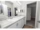 Bathroom featuring dual sinks, modern fixtures, and wood-look flooring at 3862 Willow Ridge Dr, Lakeland, FL 33810