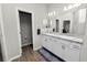 Bright bathroom with double sink vanity, wood-look flooring, and modern fixtures at 3862 Willow Ridge Dr, Lakeland, FL 33810