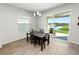 Dining table near sliding glass doors with view of the lake and the community's landscaping at 3862 Willow Ridge Dr, Lakeland, FL 33810