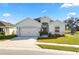 Charming single-story home with a well-manicured lawn, two-car garage, and inviting entrance at 3862 Willow Ridge Dr, Lakeland, FL 33810