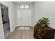 Inviting foyer with wood-look floors, a decorative cabinet, and a view of the front door at 3862 Willow Ridge Dr, Lakeland, FL 33810