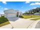 Inviting front exterior highlighting a lush green lawn, mature trees, and a spacious driveway at 3862 Willow Ridge Dr, Lakeland, FL 33810