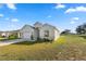 Beautiful front exterior with lush green lawn, landscaping, and a glimpse of a tranquil pond at 3862 Willow Ridge Dr, Lakeland, FL 33810