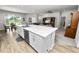 Kitchen island with stainless dishwasher, marble countertop, and an open view to the breakfast nook at 3862 Willow Ridge Dr, Lakeland, FL 33810