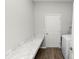 Bright laundry room featuring marble-look countertops and a washer, offering style and function at 3862 Willow Ridge Dr, Lakeland, FL 33810