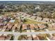 An aerial view highlights the neighborhood layout, surrounded by trees and a nearby lake at 3901 Oak Loop # 33, Mulberry, FL 33860