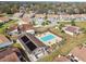 An aerial view shows the pool and surrounding neighborhood with lush landscaping and well-maintained properties at 3901 Oak Loop # 33, Mulberry, FL 33860