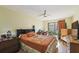 Bedroom with ceiling fan, wood floors, desk and view to garden at 3901 Oak Loop # 33, Mulberry, FL 33860