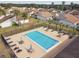 A pristine community pool offers residents a refreshing escape with ample lounge seating and umbrellas at 3901 Oak Loop # 33, Mulberry, FL 33860