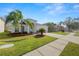 Attractive house with palm trees, neat landscaping, and a driveway at 3961 Hampton Hills W Dr, Lakeland, FL 33810