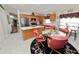 A dining area sits adjacent to the kitchen, boasting wood cabinetry and stainless steel appliances at 3961 Hampton Hills W Dr, Lakeland, FL 33810