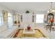 Bright and airy living room featuring white walls, a white sofa, built-in cabinet, and breakfast nook at 3961 Hampton Hills W Dr, Lakeland, FL 33810