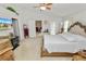 This main bedroom features a ceiling fan, ensuite access, and a neutral color palette at 3961 Hampton Hills W Dr, Lakeland, FL 33810