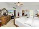 This main bedroom has a TV, ceiling fan, and access to the ensuite and walk-in closet at 3961 Hampton Hills W Dr, Lakeland, FL 33810