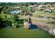 Aerial view of a lake with a gazebo, bridge, pool, and residences of the community at 4002 Sunset Lake Dr, Lakeland, FL 33810