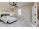 Bedroom with white walls, ceiling fan, plantation shutters and ensuite bathroom at 4002 Sunset Lake Dr, Lakeland, FL 33810