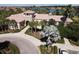 A well manicured lawn leads to an opulent house with a terracotta tile roof and views of the lake behind at 4002 Sunset Lake Dr, Lakeland, FL 33810