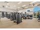 State-of-the-art fitness center with weight machines, treadmills, and free weights, boasting ample space and natural light at 4002 Sunset Lake Dr, Lakeland, FL 33810