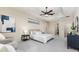 Serene main bedroom with a tray ceiling, ceiling fan, and an en-suite bathroom at 4002 Sunset Lake Dr, Lakeland, FL 33810