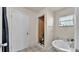 Bathroom featuring a white tiled floor, sink and toilet, as well as an incomplete tiled shower at 4035 Crews Ln, Lakeland, FL 33813