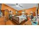 Cozy bedroom featuring stylish wood furniture and warm orange walls at 4035 Crews Ln, Lakeland, FL 33813