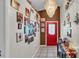 Elegant entryway with a crystal chandelier, a red front door, and decorative wall decor at 4035 Crews Ln, Lakeland, FL 33813