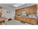 Bright kitchen featuring wood cabinets, white tile countertops, and neutral tile floors at 4035 Crews Ln, Lakeland, FL 33813