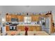 Traditional kitchen featuring stainless steel appliances, natural cabinets, and a bright window at 4035 Crews Ln, Lakeland, FL 33813