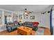 Comfortable living room with wood-look flooring, ceiling fan and classic black leather couches at 4035 Crews Ln, Lakeland, FL 33813