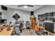 A music room with instruments and sound dampening, featuring two rolling chairs and a neutral color scheme at 4035 Crews Ln, Lakeland, FL 33813