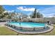 A fenced in above-ground pool featuring plenty of chairs, a table and a diving board at 4035 Crews Ln, Lakeland, FL 33813