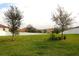 Expansive backyard featuring lush green grass and a privacy fence at 4080 Prima Lago Cir, Lakeland, FL 33810