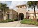 Attractive exterior building with stone accents, arched entryway, and well-maintained landscaping at 4080 Prima Lago Cir, Lakeland, FL 33810