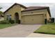 Charming home showcasing a well-maintained exterior with a tile roof and a spacious two-car garage at 4080 Prima Lago Cir, Lakeland, FL 33810