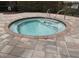 Inviting community hot tub featuring paver patio and stainless steel grab rails for easy access and relaxation at 4080 Prima Lago Cir, Lakeland, FL 33810