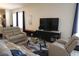 Living room featuring tile floors, comfortable furniture, and a large television at 4080 Prima Lago Cir, Lakeland, FL 33810