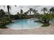 Sparkling community swimming pool surrounded by palm trees, offering a refreshing retreat for residents at 4080 Prima Lago Cir, Lakeland, FL 33810