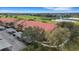 Great aerial view of condos, covered parking and golf course with pond in the background at 417 Enclave Pl # 2, Lakeland, FL 33803