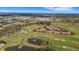 Aerial view of community golf course, condos, roads, and nature trails at 417 Enclave Pl # 2, Lakeland, FL 33803