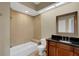 Bathroom featuring a tiled shower-tub combo with a black granite vanity at 417 Enclave Pl # 2, Lakeland, FL 33803