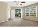 Bedroom featuring carpet floor, large window and door leading to patio at 417 Enclave Pl # 2, Lakeland, FL 33803