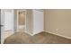 Neutral-toned bedroom featuring a carpeted floor, closet, and doorway leading to the bathroom at 417 Enclave Pl # 2, Lakeland, FL 33803