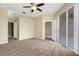 Spacious main bedroom with carpet floors and sliding glass door to a screened patio at 417 Enclave Pl # 2, Lakeland, FL 33803