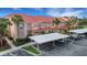 Exterior shot showcasing condos with covered parking and well maintained landscaping at 417 Enclave Pl # 2, Lakeland, FL 33803