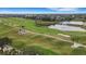 View of community golf course with mature palm trees, sand traps, and walking path at 417 Enclave Pl # 2, Lakeland, FL 33803